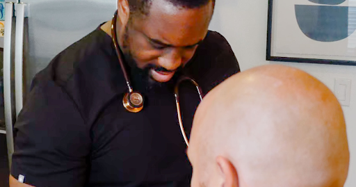 Concierge physician performing a proactive health assessment with a patient during an in home visit 
