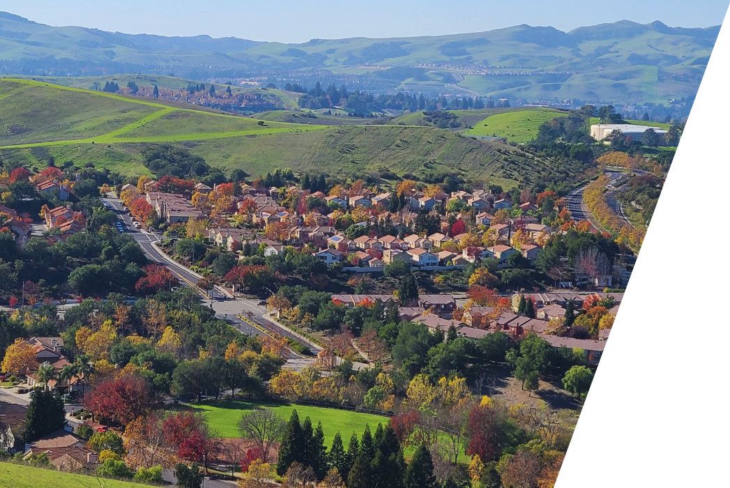 An aerial view of San Ramon, California residential area with mountains in the background.