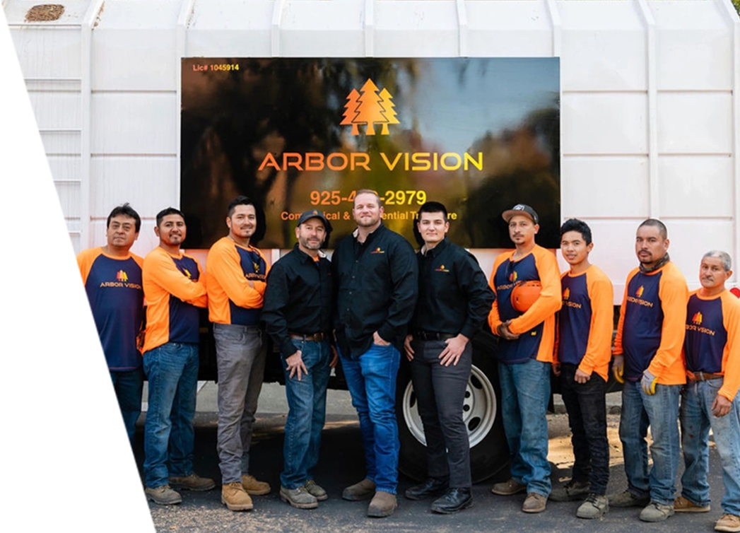 Arbor Vision team in their uniform standing in from of their service car