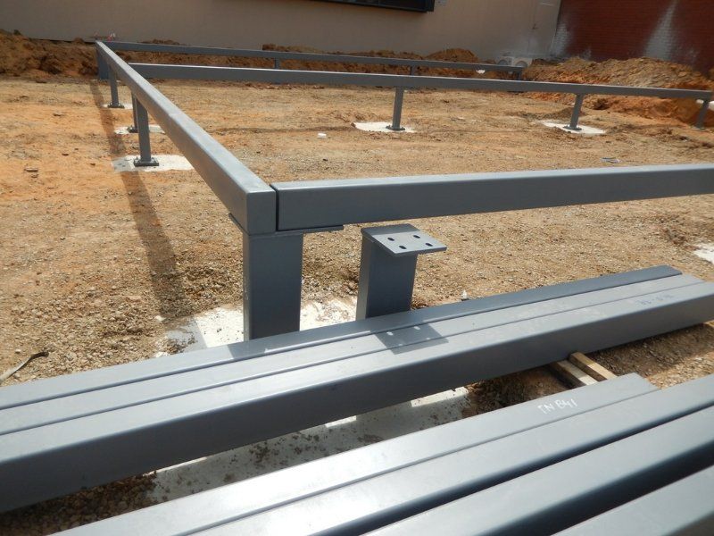 Metal Pole Next to a Concrete Box — Mawson Constructions in Kialla, VIC