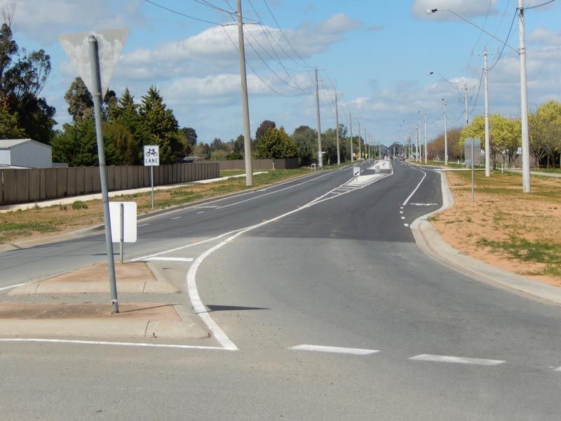 A Road with a white sign that says no left turns on it — Mawson Constructions in Kialla, VIC