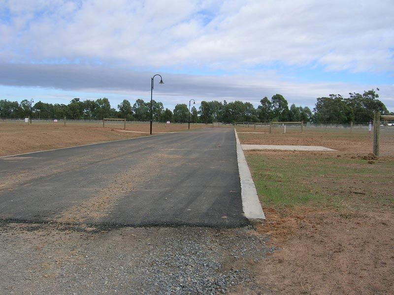 A Road Going Through a field with trees in the Background — Mawson Constructions in Kialla, VIC