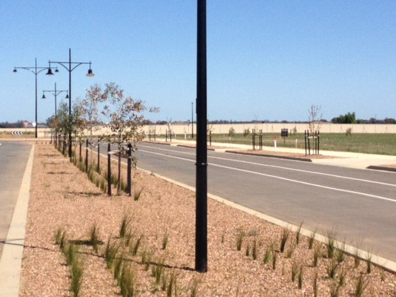 A row of Street Lights Along the side of a road — Mawson Constructions in Kialla, VIC