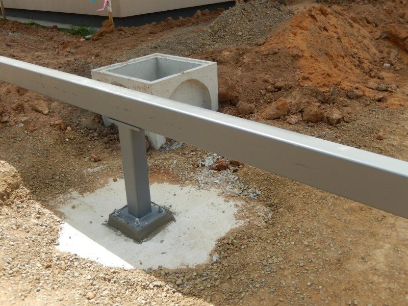 Metal Post is Sitting on a Concrete Base — Mawson Constructions in Kialla, VIC