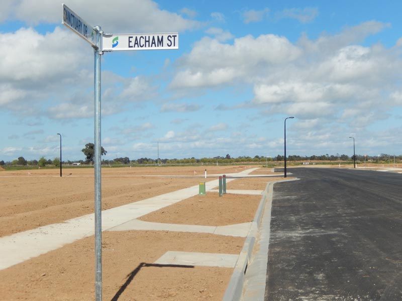 Eacham Street sign on the side of a road — Mawson Constructions in Kialla, VIC