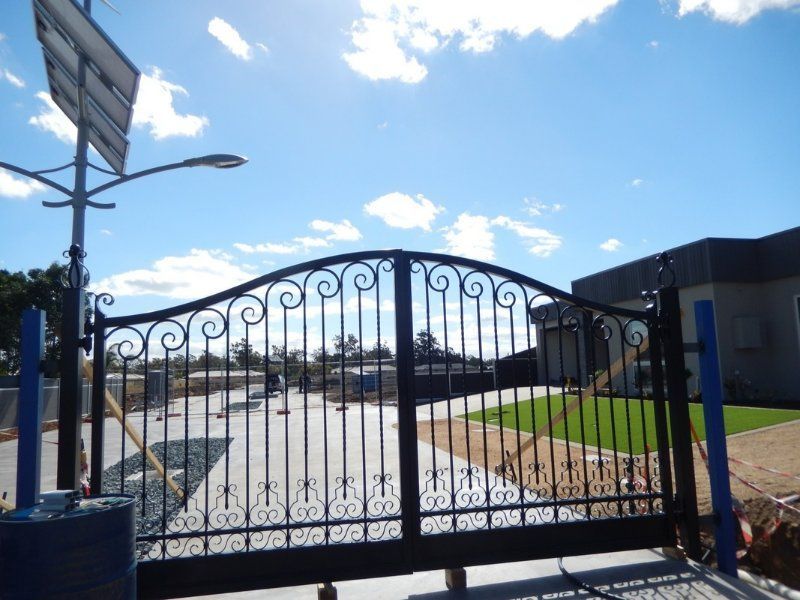A Wrought Iron gate in Front of a House — Mawson Constructions in Kialla, VIC
