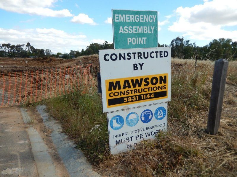 A Sign that says Emergency Assembly point Constructed by Mawson Constructions on it — Mawson Constructions in Kialla, VIC