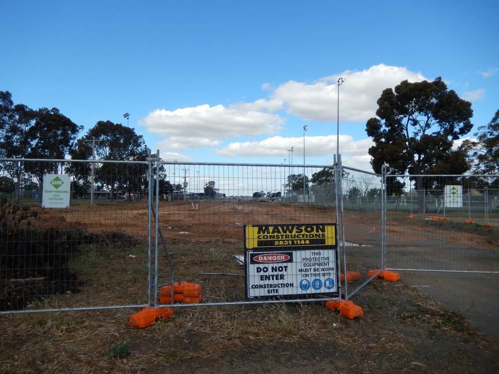 A Fence with a sign that says Warning on it — Mawson Constructions in Kialla, VIC