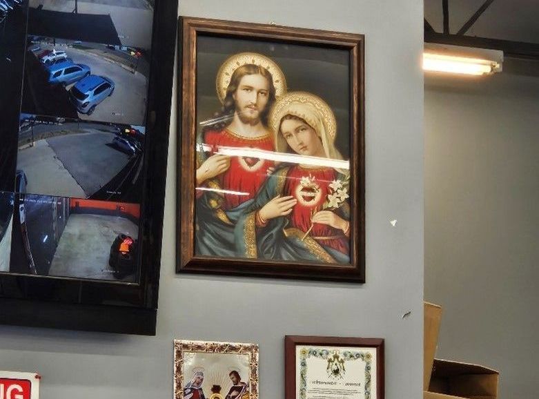 A picture of jesus and mary is hanging on a wall