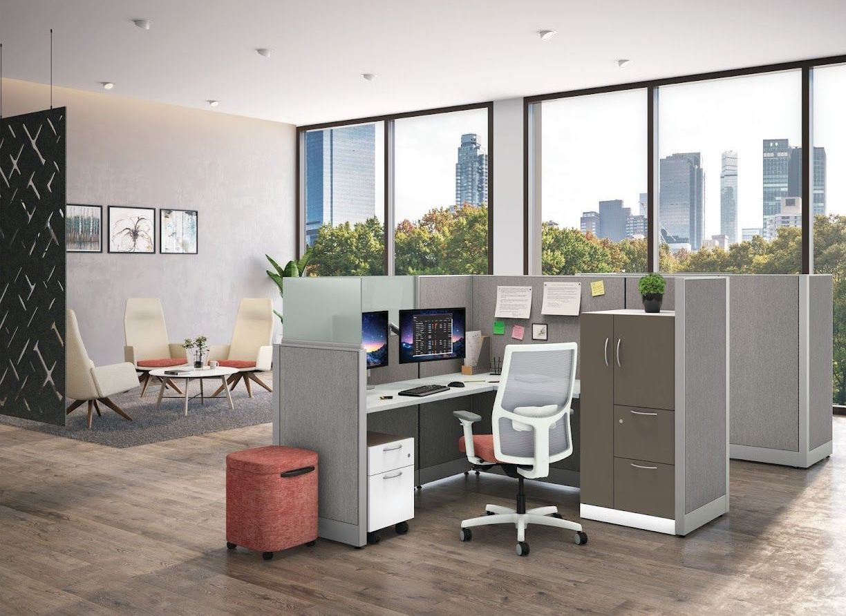 A cubicle with a computer desk and chair in an office.