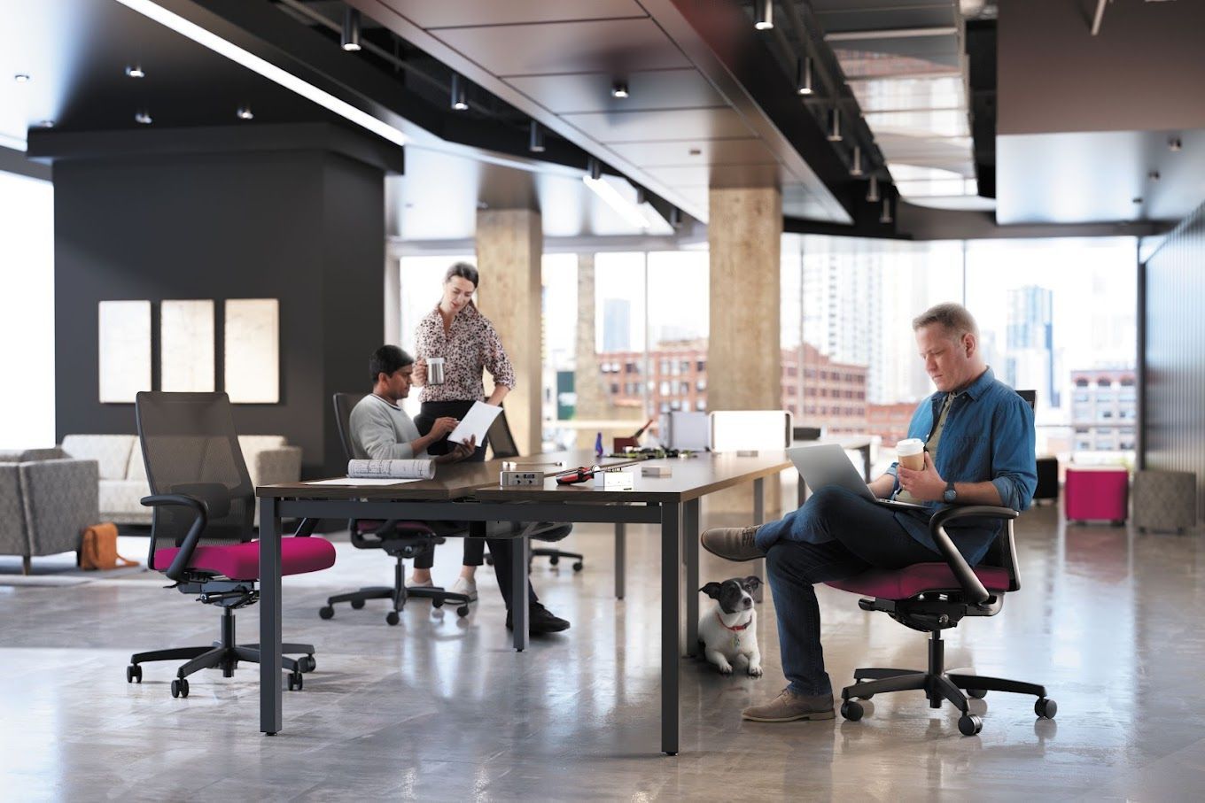 A group of people are sitting at desks in an office.