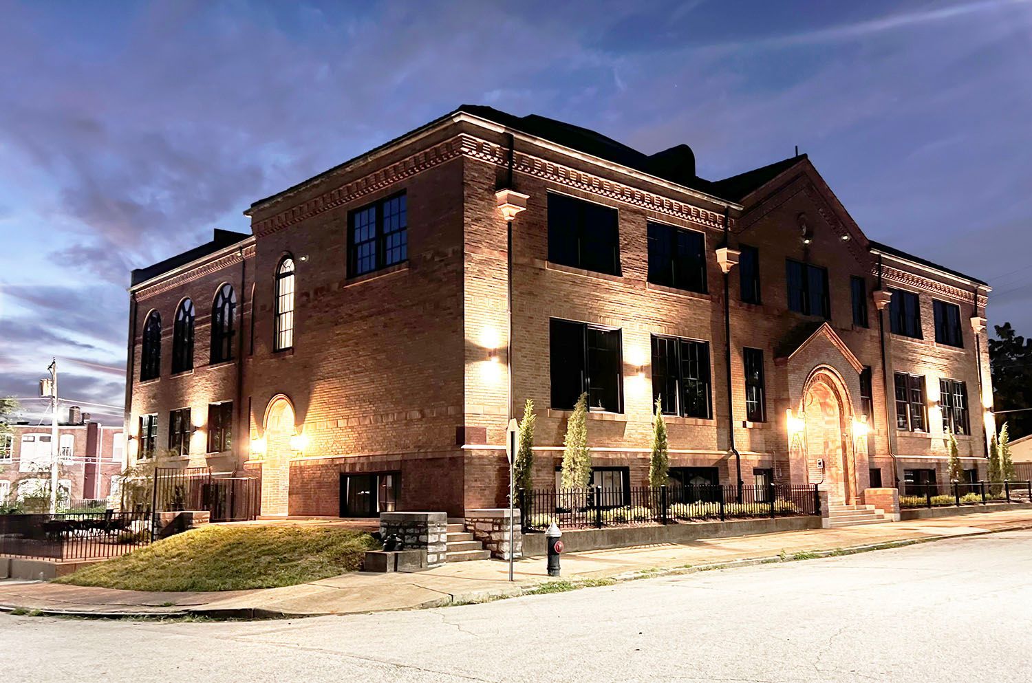 A large brick building is lit up at night.