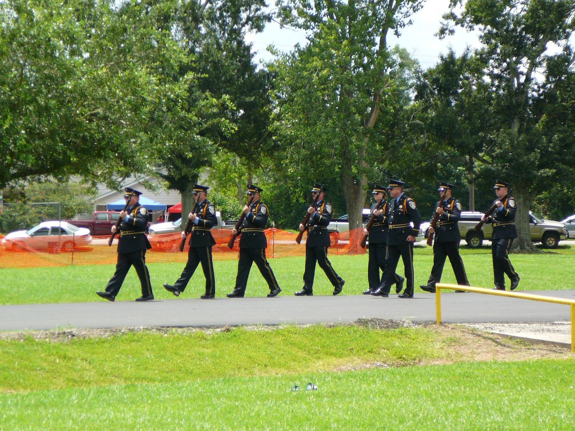 A group of police officers marching down a road