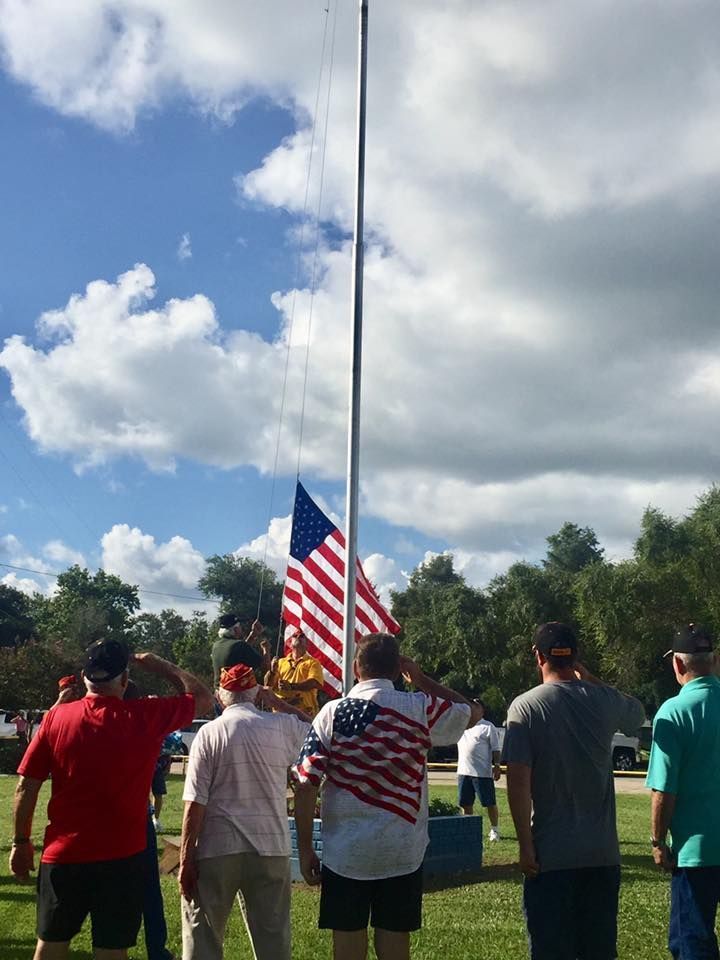A group of people standing in front of an american flag