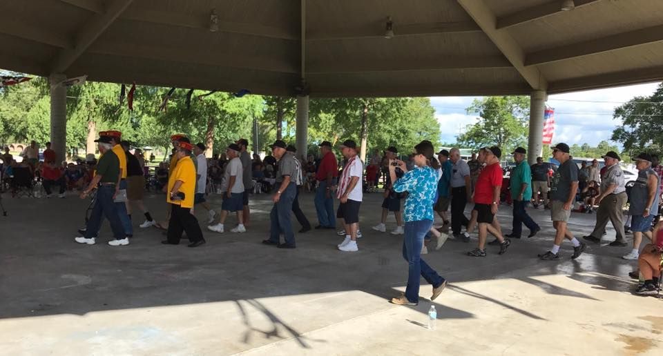 A group of people are walking under a pavilion.