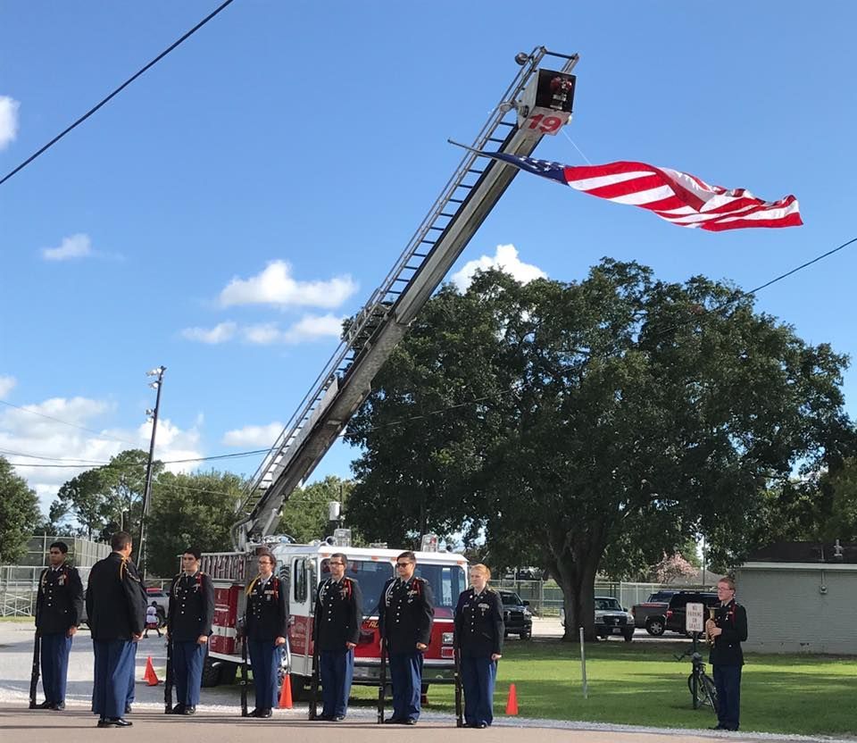 A group of men standing in front of a fire truck