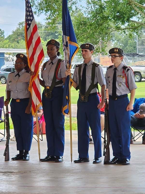 A group of people in military uniforms holding flags