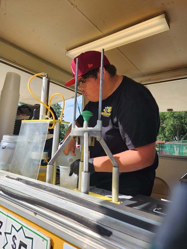 A man in a red hat is working on a machine