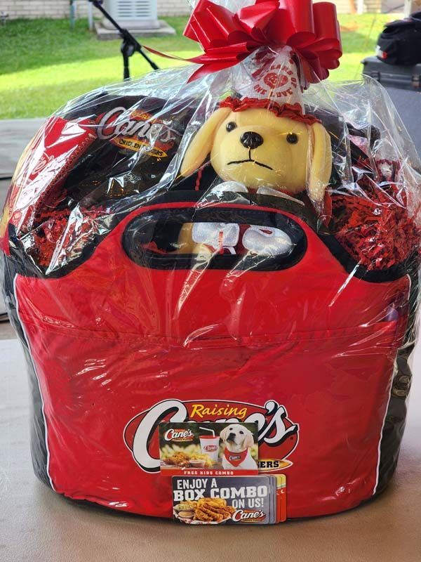 A red cooler with a stuffed dog in it.