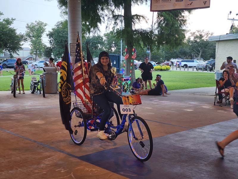 A person is riding a bike with the number 063 on the back