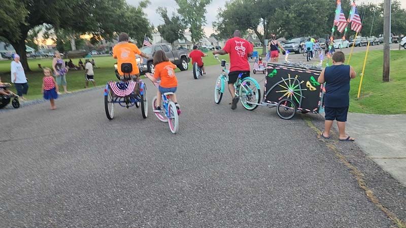 A group of people are riding bicycles down a street.