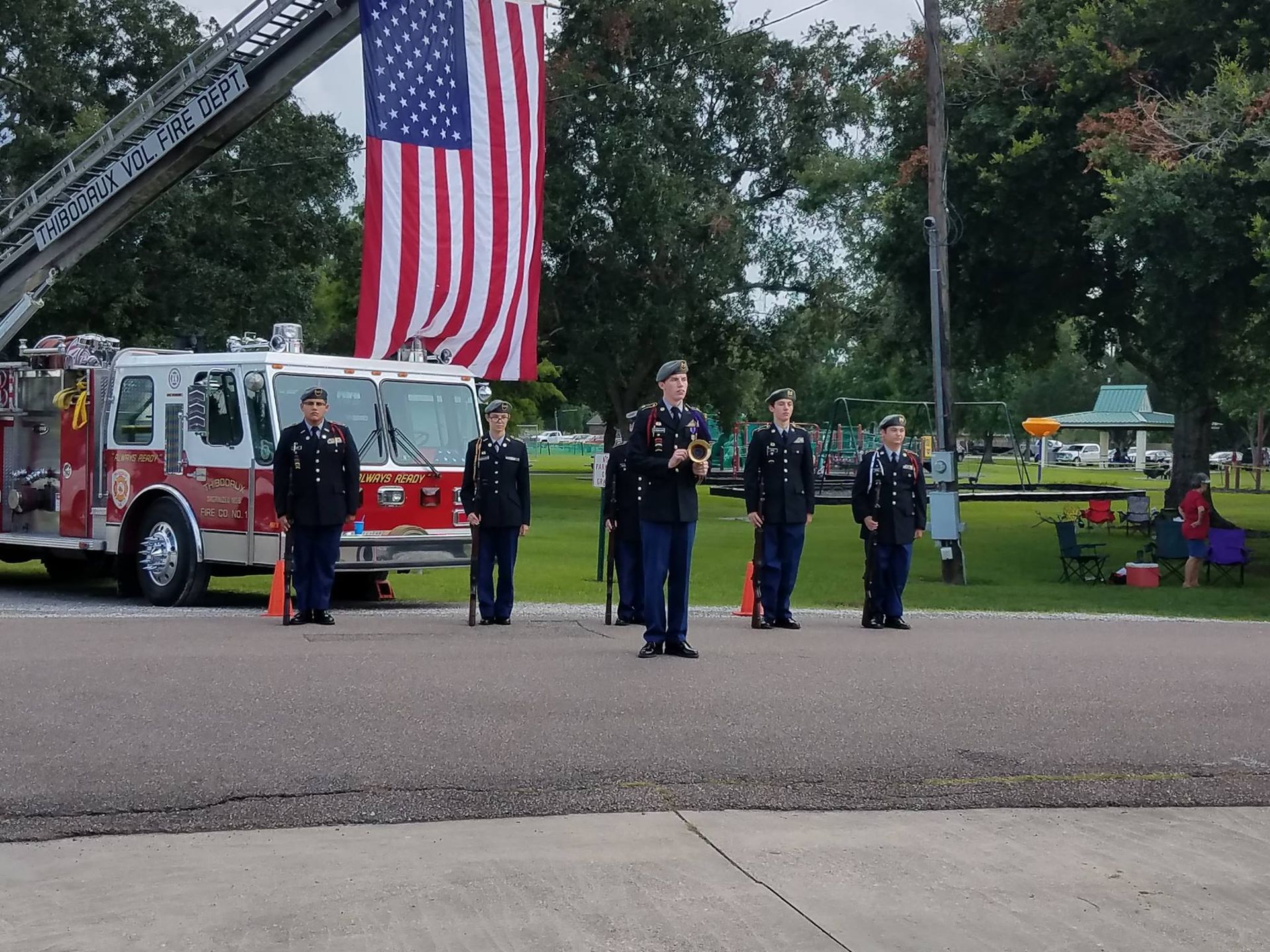 A group of soldiers standing in front of a fire truck