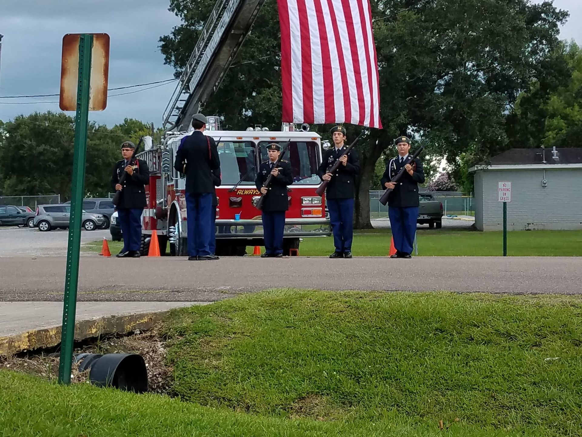 A group of men standing in front of a fire truck