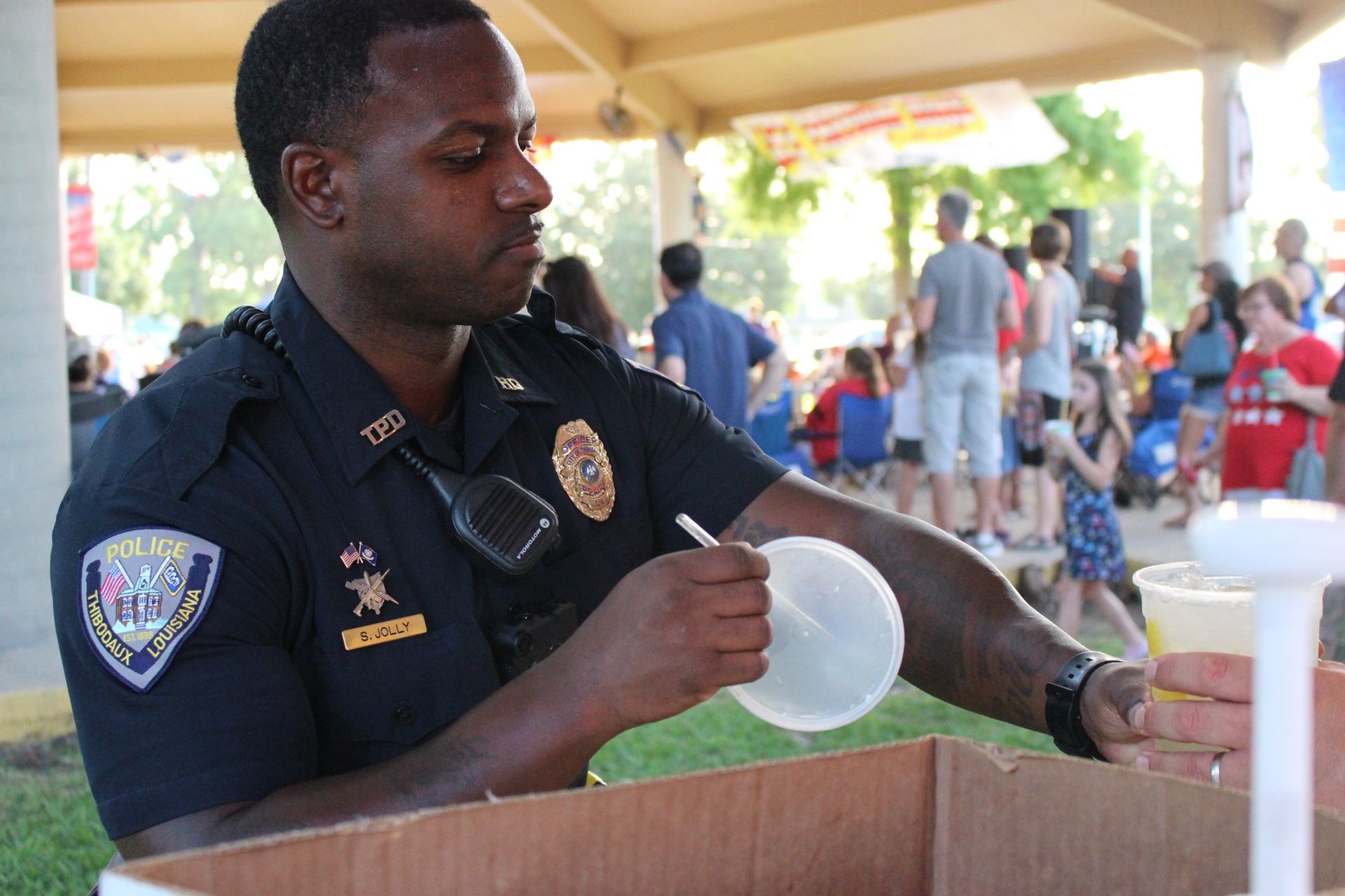 A man in a police uniform is writing on a piece of paper