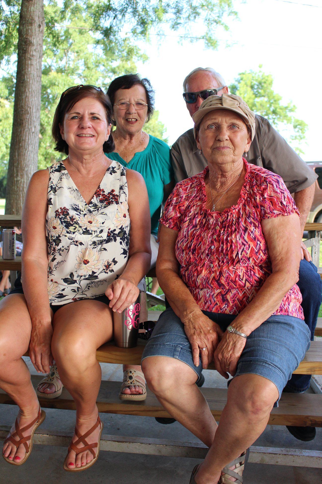 A group of people are sitting on a picnic table.