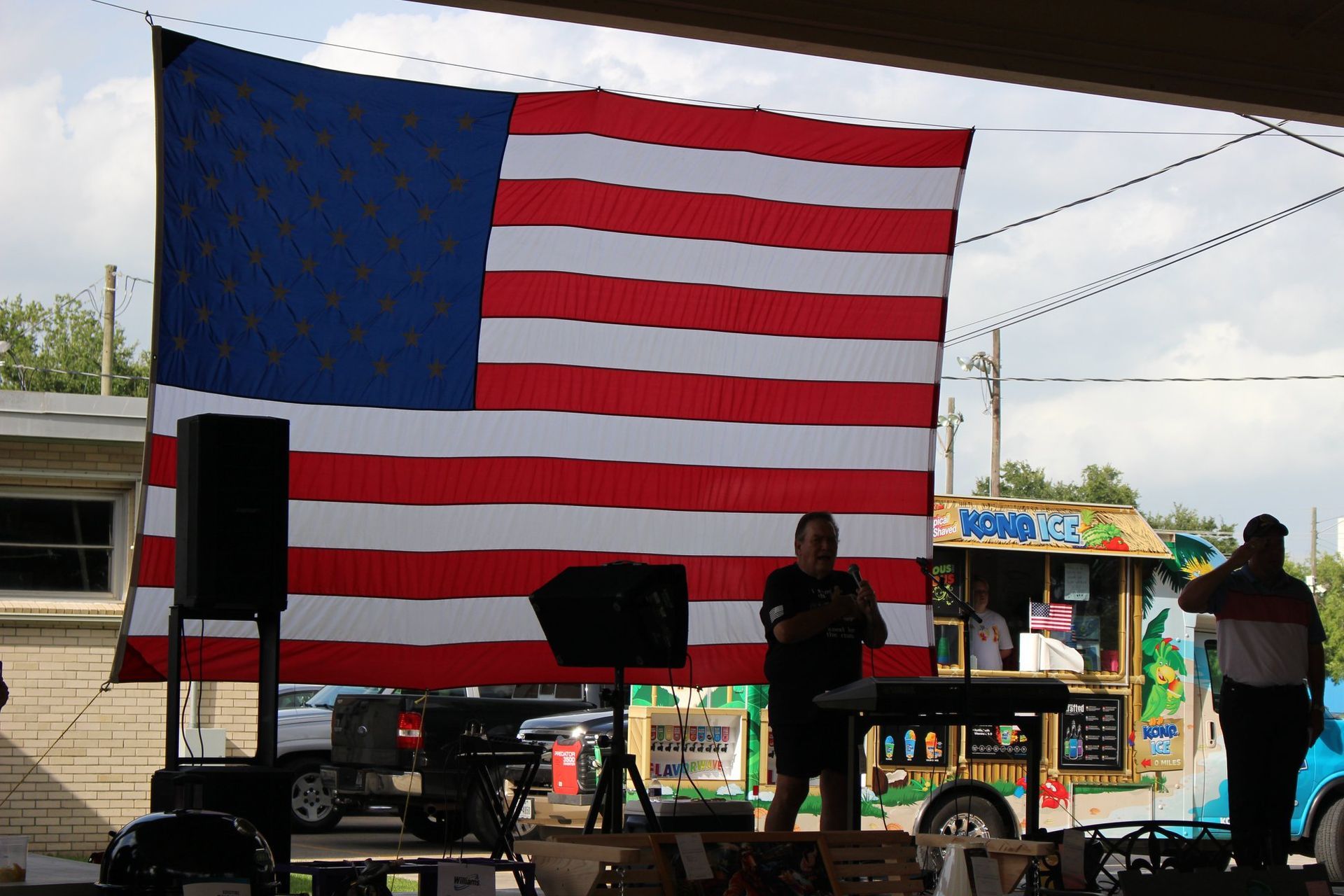 A man playing a musical instrument in front of an american flag