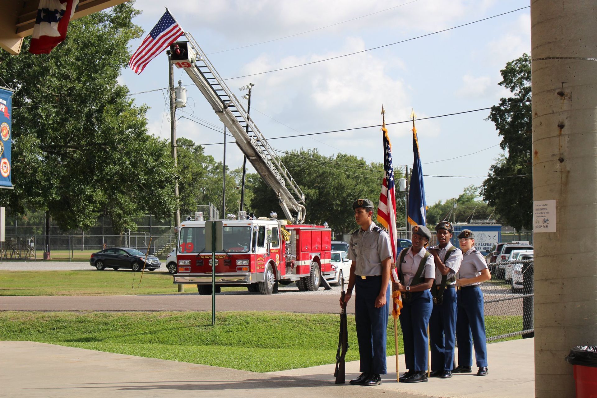 A group of people standing in front of a fire truck