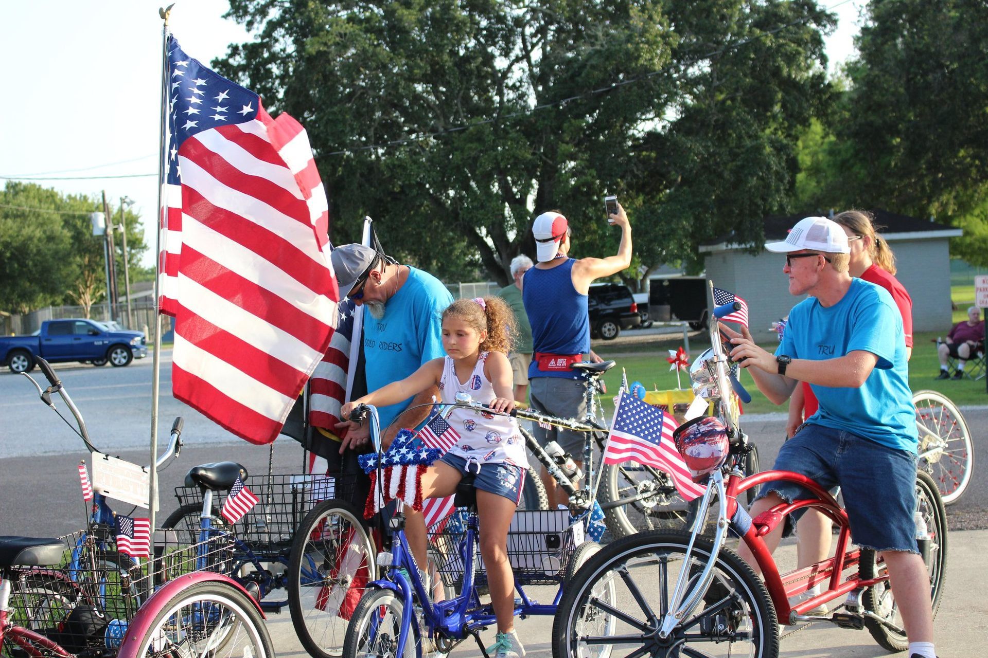 A group of people are riding bicycles decorated with american flags.