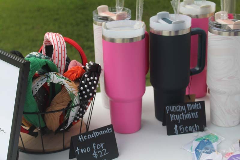 A table with a sign that says headbands two for $ 22