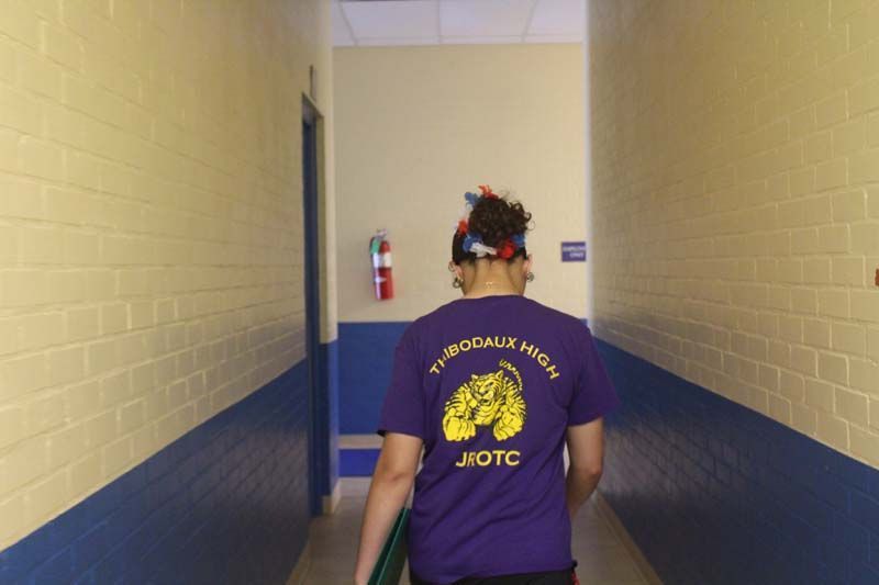 A person wearing a purple shirt that says jiotc