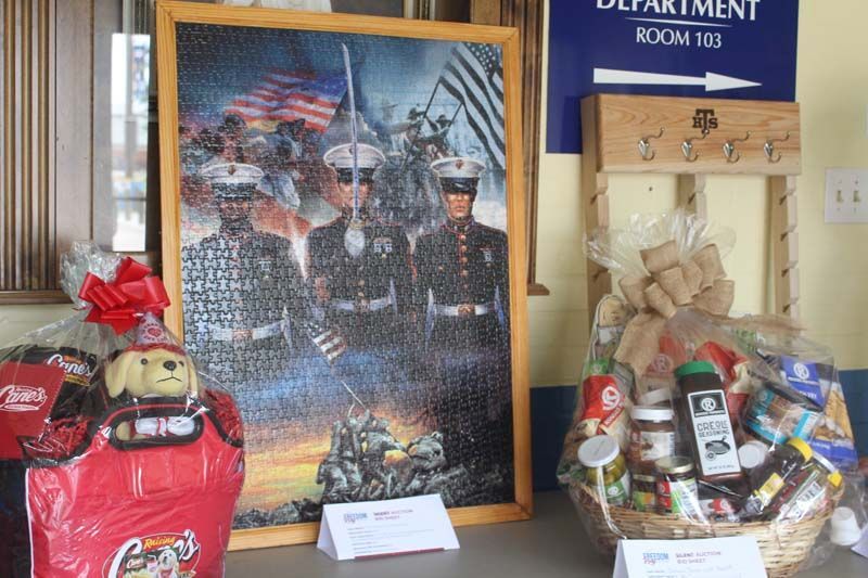 A picture of soldiers is on a table next to a basket of food.