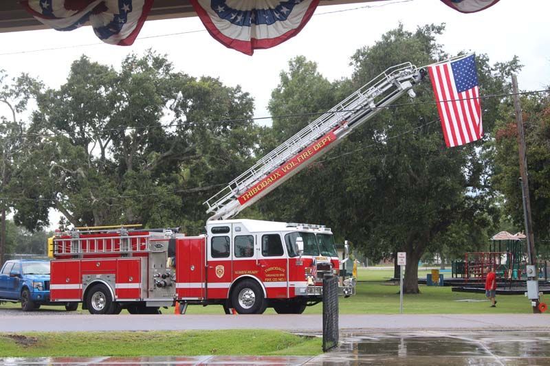 A fire truck with a flag hanging from it