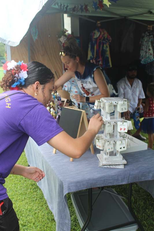 A man in a purple shirt is working on a table