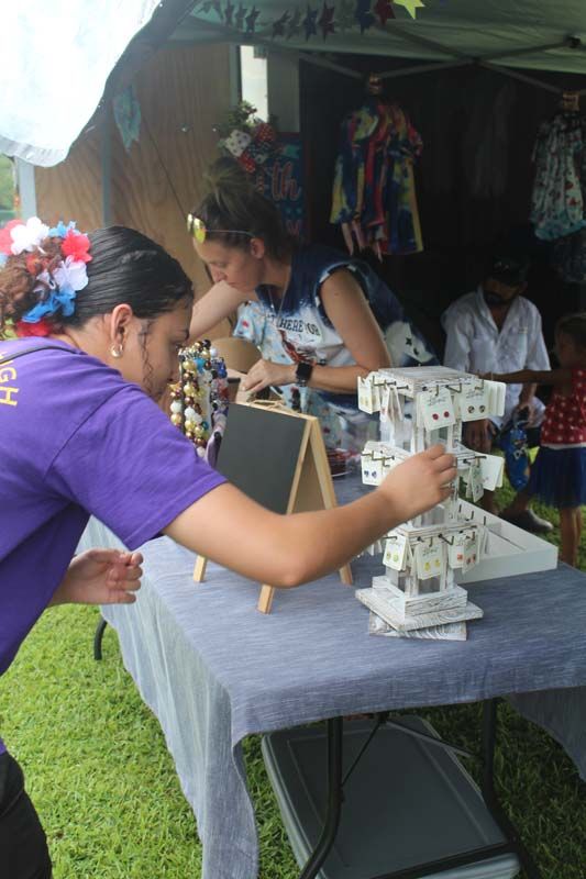 A woman in a purple shirt is working on a table