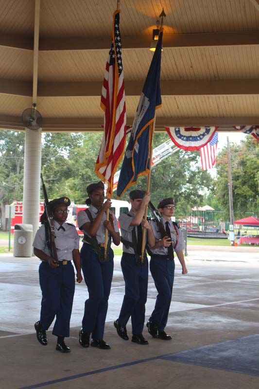 A group of soldiers are marching with flags in a parade.