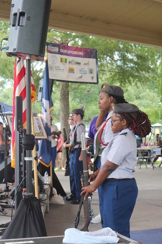 A group of people standing in front of a sign that says ' us army ' on it