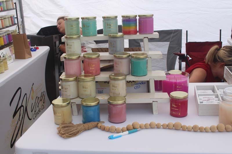 A table with a bunch of jars of candles on it