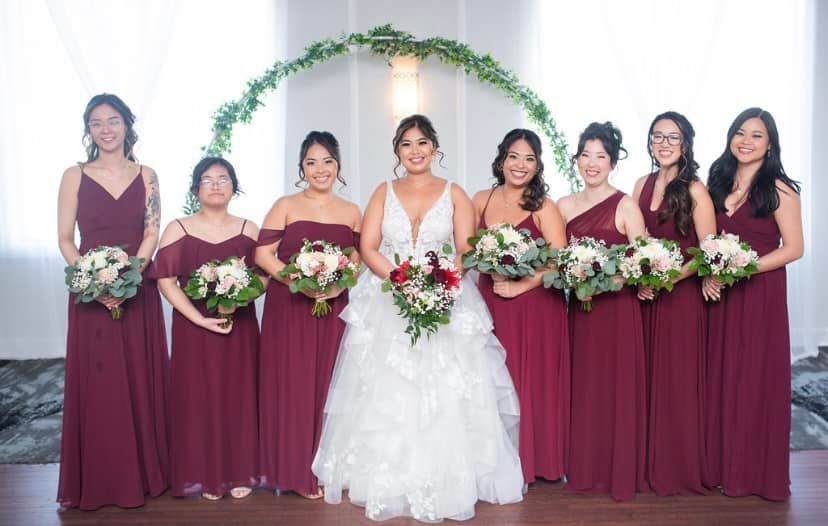 A bride and her bridesmaids are posing for a picture