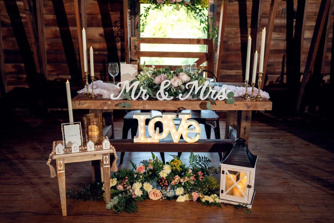 A wooden table with a sign that says Mr and Mrs