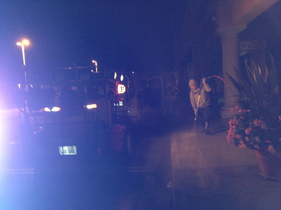 A blurry picture of people standing outside of a building at night