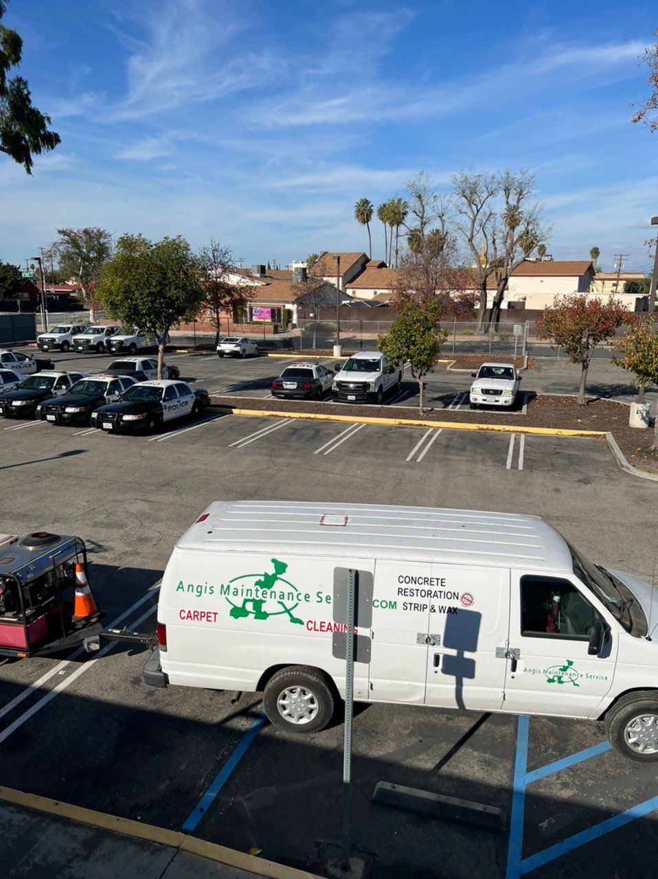 A white van is parked in a parking lot