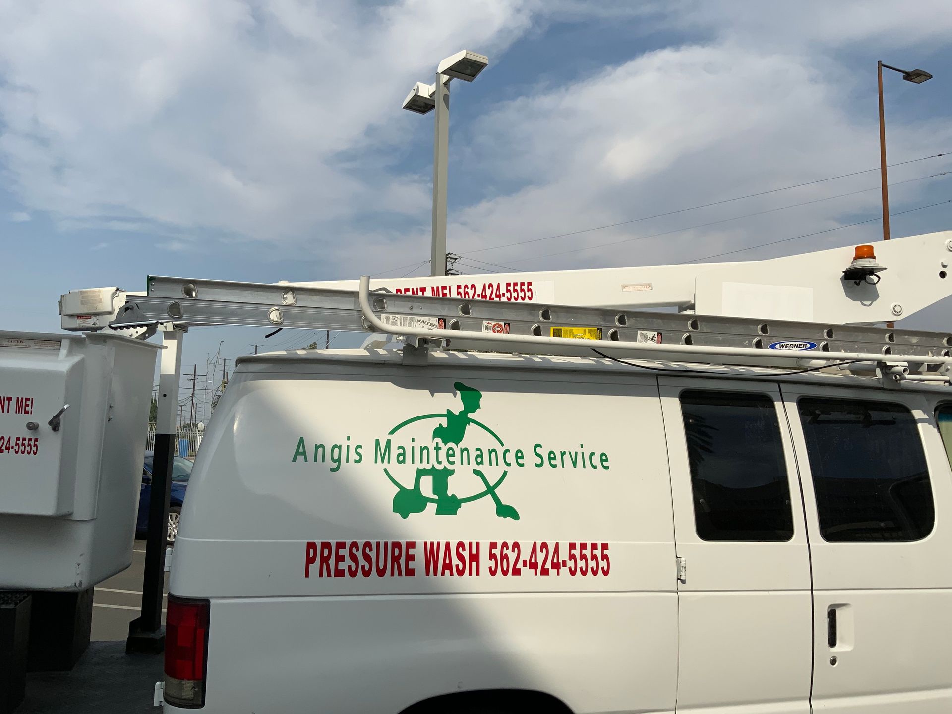 A white van says angis maintenance service on the side