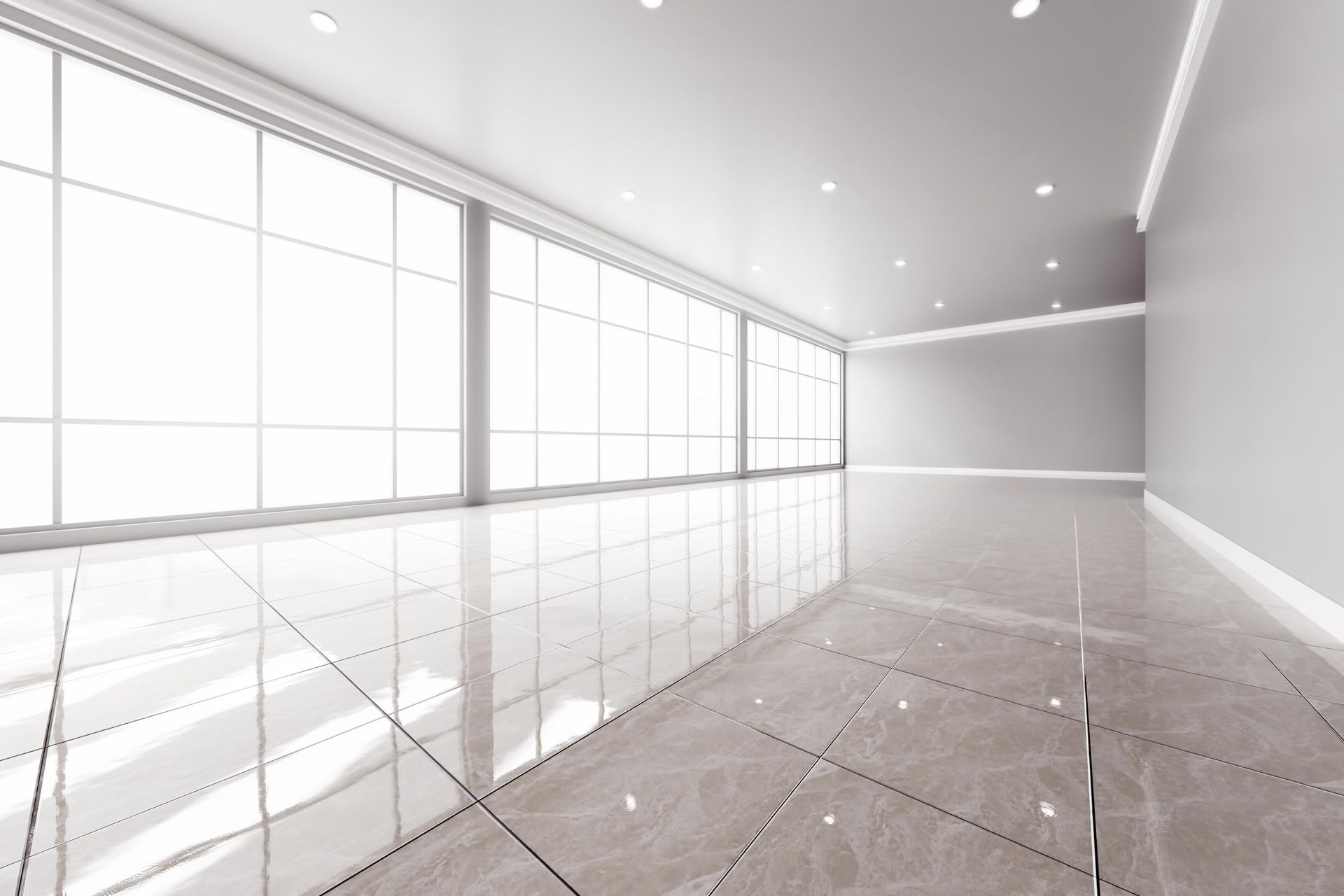 An empty room with a marble floor and lots of windows.
