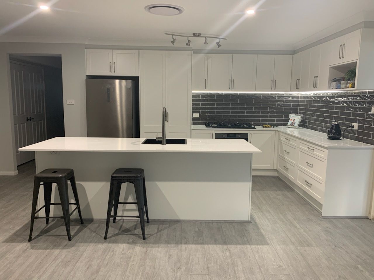 A Wok Is Cooking On A Stove In A Kitchen — The Kitchen & Bathroom Doctor in Raymond Terrace, NSW