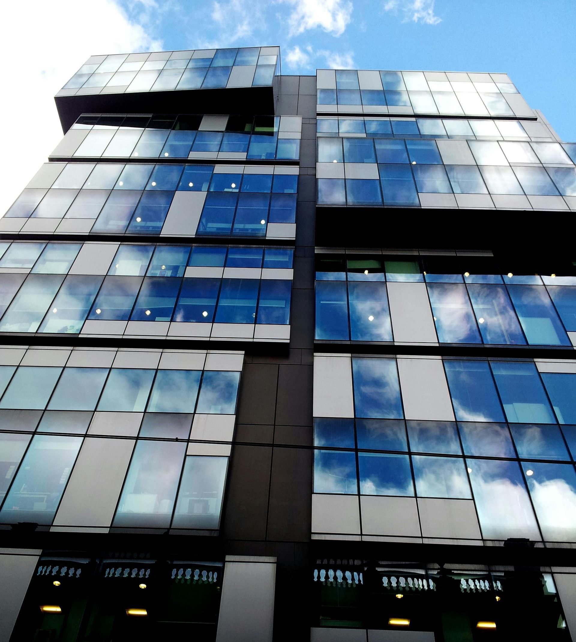 Looking up at a tall building with a lot of windows