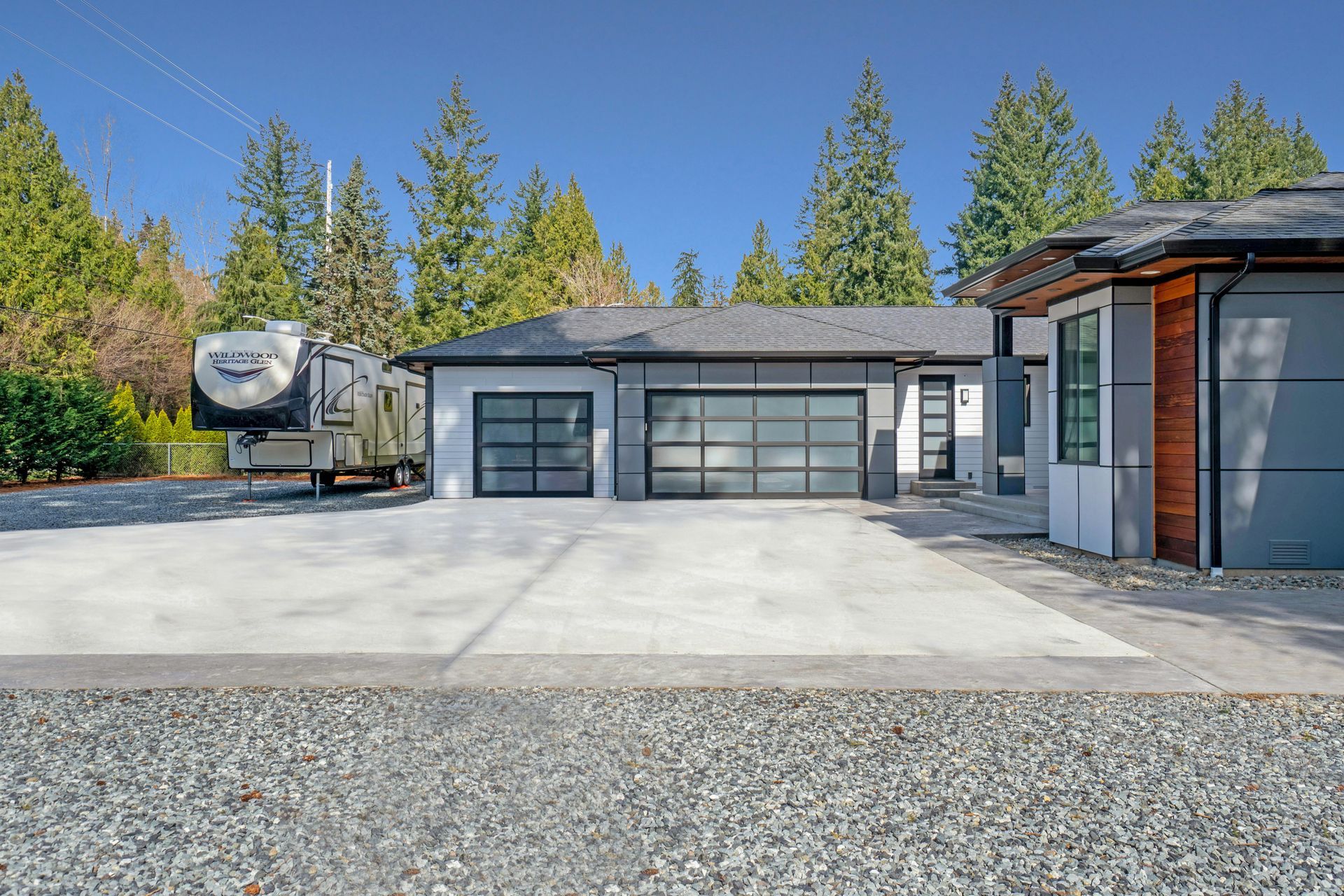 A house with a trailer parked in front of it.